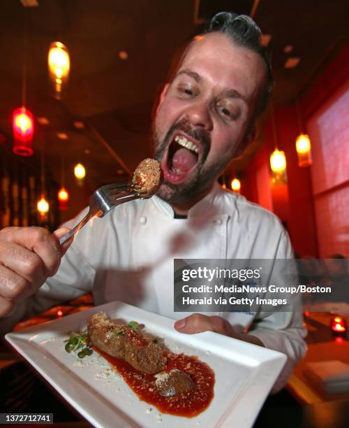 Nuno Alves, the chef at Tavolo pours fat onto his 'Nuno's spicy sausage', which they are cooked in, at his restaurant. Tuesday, March 18, 2014.