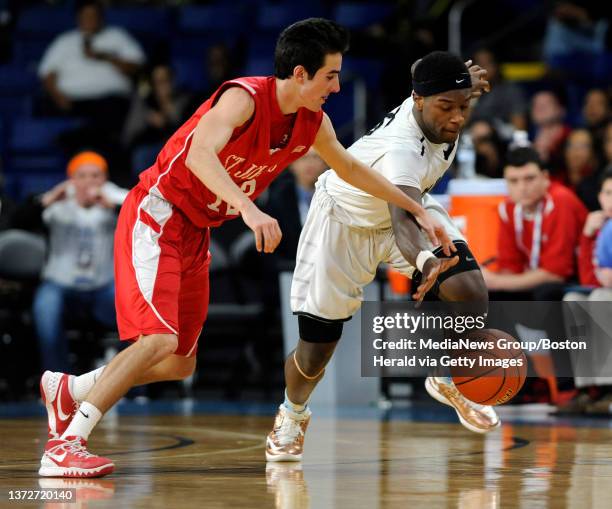 St. John's of Shrewsbury guard Alex Bradley, left, battles for a loose ball with Cambridge Rindge & Latin School Jakigh Dottin Mills during the third...