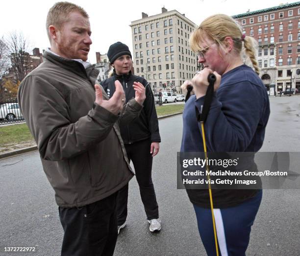 Great in 08 participants workout on the Boston Common.Rachel Bremislt does biceps curl with instruction from coach Peter Flavell as Jenny Shea...
