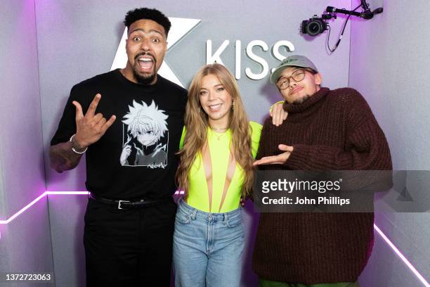 Becky Hill poses with with presenters Jordan Banjo and Perri Kiely during a visit to KISS FM at KISS FM on February 25, 2022 in London, England.