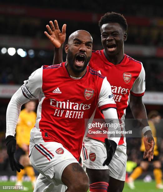 Alexandre Lacazette of Arsenal celebrates their sides second goal with team mate Bukayo Saka during the Premier League match between Arsenal and...