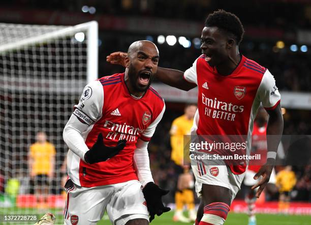 Alexandre Lacazette of Arsenal celebrates their sides second goal with team mate Bukayo Saka during the Premier League match between Arsenal and...