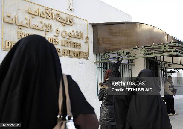 Student of the Faculty of Arts and letters in Manuba, wearing a niqab, flashes the Victory sign on January 18, 2012 in Tunis. Four students wearing...
