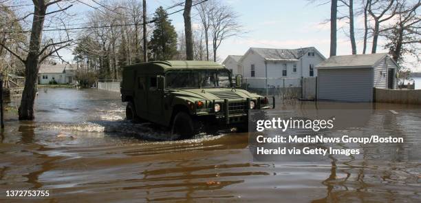 Members of the National Guard's 772 Military Police Company patrol the flooded streets of "Clark Shores" past the home of 92 year old Evelyn Pina who...