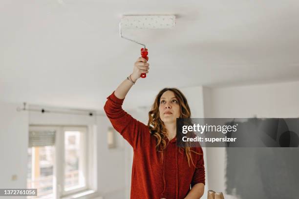 young  woman painting  room - painted ceiling stock pictures, royalty-free photos & images