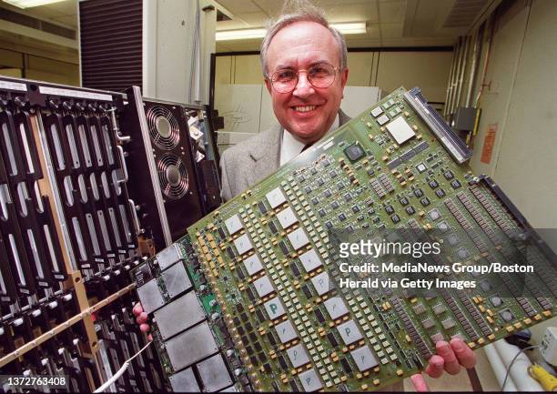 George Chamillard, President and CEO of Teradyne views a circuit board for one of the company's instruments.