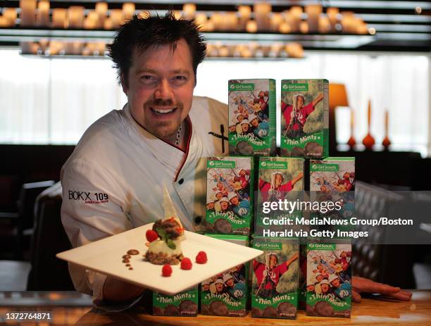 Executive Chef Evan Percoco of Bokx 109 restaurant in the Hotel Indigo, holds up his Thin Mint Cheesecake from which the sales will be donated to...