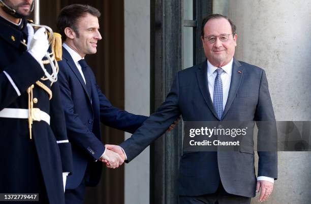 French President Emmanuel Macron escorts Former French President Francois Hollande after their meeting to discuss the Russian attack on Ukraine in...