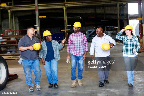 multiracial workers walking into warehouse loading dock - footwear manufacturing stock pictures, royalty-free photos & images