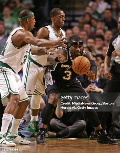 San Antonio Spurs shooting guard Stephen Jackson dishes off the pass under pressure of Boston Celtics small forward Paul Pierce and Boston Celtics...