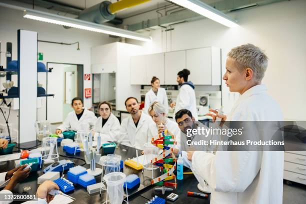 medical laboratory with students listening to tutor - indian education health science and technology stockfoto's en -beelden