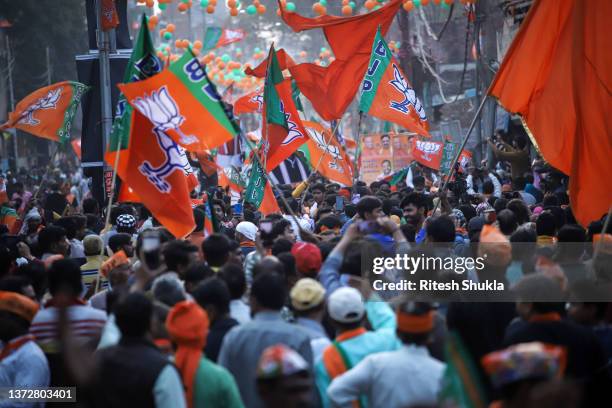 Supporters of Uttar Pradesh's Chief Minister and Bharatiya Janata Party candidate Yogi Adityanath line the streets during a roadshow during state...