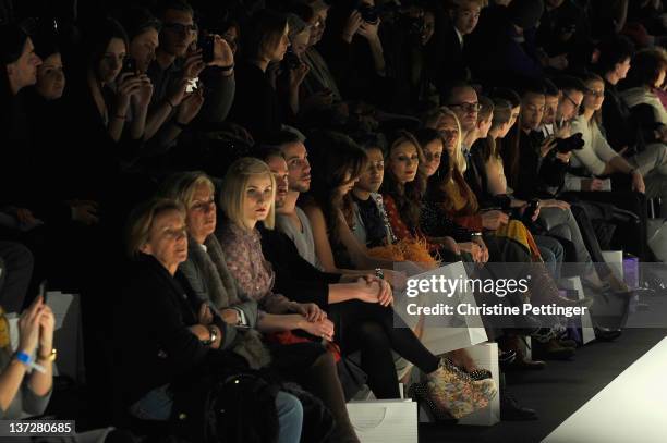 Liliana Mattaeus and Nazan Eckes watch a model walk the runway at the Rebekka Ruetz Autumn/Winter 2012 fashion show during Mercedes-Benz Fashion Week...