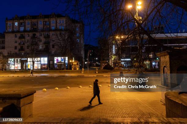 Man walks on an empty street close to Independence Square ahead of the nights curfew on February 25, 2022 in Kyiv, Ukraine. Yesterday, Russia began a...