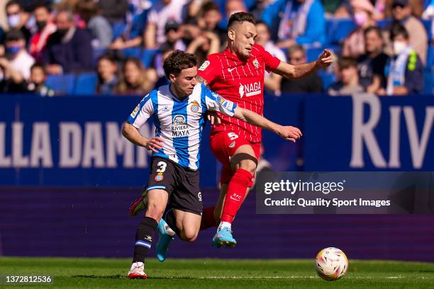Adria Pedrosa of RCD Espanyol competes for the ball with Lucas Ocampos of Sevilla FC during the LaLiga Santander match between RCD Espanyol and...