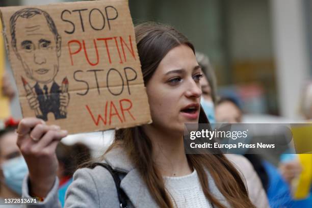 Woman, holding a banner reading 'StopPutin Stop War', takes part in a second rally to support Ukraine following attacks received from Russia, at the...