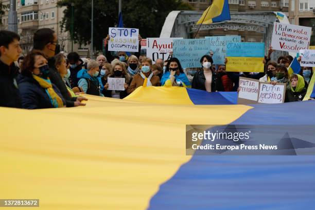 Woman, holding a banner reading 'StopPutin Stop War', takes part in a second rally to support Ukraine following attacks received from Russia, at the...