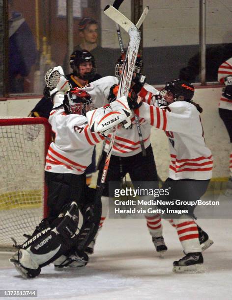 Woburn's goaltender Becca Papa celebrates her win with teammates Solleen Callahan and Shawna Walsh as Worburn takes on Fontbonne in Girls Hockey....