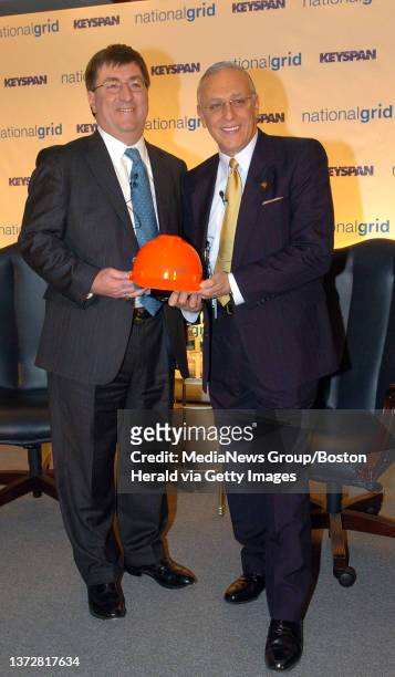 National Grid President and CEO Michael Jesanis and Keyspan Chairman CEO Robert Catell greet during the press conference for the merger of their...
