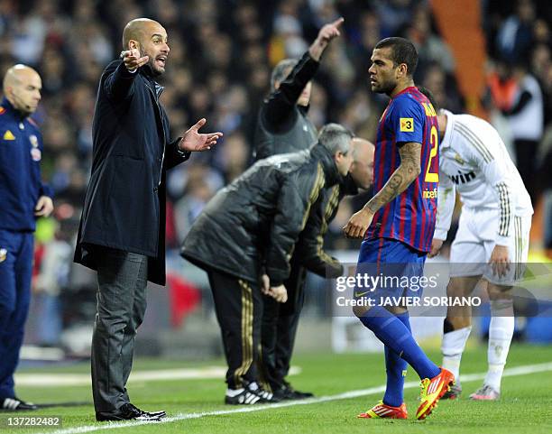 Barcelona's coach Josep Guardiola gestures in front of Barcelona's Brazilian defender Dani Alves during the Spanish Cup "El clasico" football match...