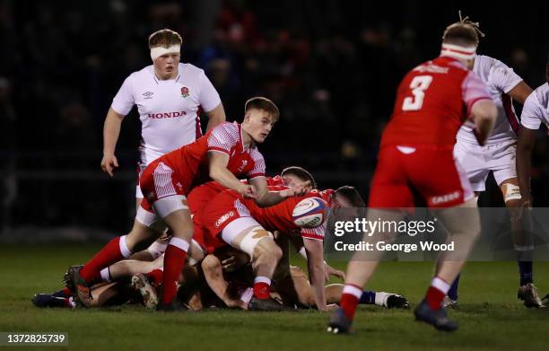 Morgan Lloyd of Wales offloads the ball during the Under-20 Six Nations match between England U20 and Wales U20 at Castle Park on February 25, 2022...