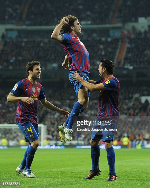Carles Puyol of FC Barcelona celebrates scoring his sides equalizing goal with his teammates Xavi Hernandez and Cesc Fabregas during the Copa del Rey...