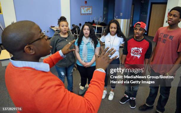 Boston,MA. Michael Bradley, Music Director at Orchard Gardens School, is seen with 8th grade students, from left, Jasmine Gandy, Ariana Vasquez,...