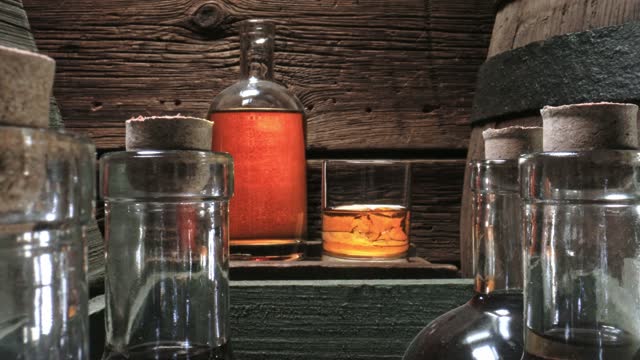 Single Malt whisky in old distillery warehouse. Glass of cognac.