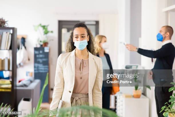 businesswoman at work post pandemic lockdown - health and safety covid stock pictures, royalty-free photos & images