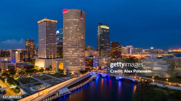 aerial view of the illuminated downtown tampa skyline in the night. - tampa florida stock pictures, royalty-free photos & images