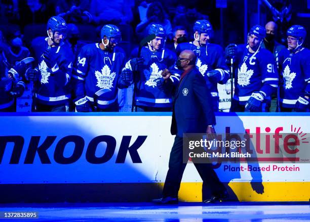 Former Toronto Maple Leafs player Val James walks to centre ice for a ceremonial puck drop to honour Black History Month before the Toronto Maple...