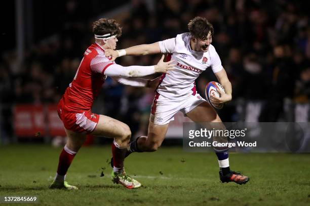 Ethan Grayson of England breaks away from Eddie James of Wales during the Under-20 Six Nations match between England U20 and Wales U20 at Castle Park...