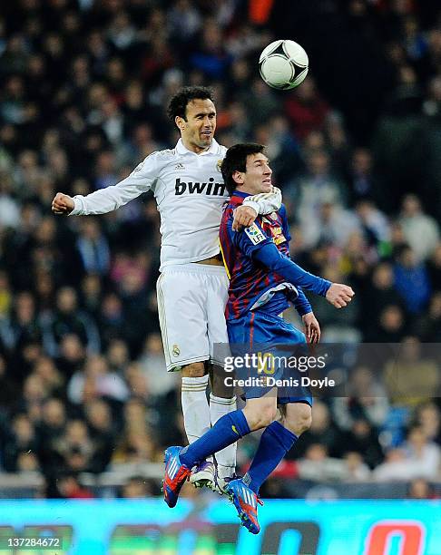 Fernando Carvalho of Real Madrid tackles Lionel Messi of Barcelona during the Copa del Rey Quarter Finals match between Real Madrid and Barcelona at...