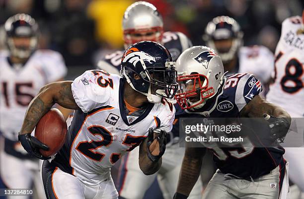Willis McGahee of the Denver Broncos runs the ball against Mark Anderson of the New England Patriots during their AFC Divisional Playoff Game at...