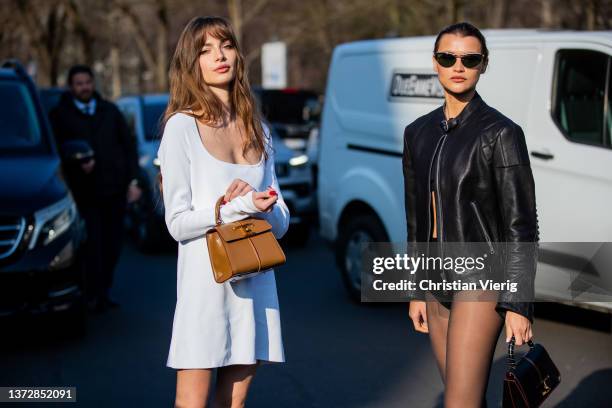 Mara Lafontan seen wearing white dress, brown bag & Chloe Lecareux seen wearing black jacket, sheer tights, cropped top, mini shorts, brown bag...