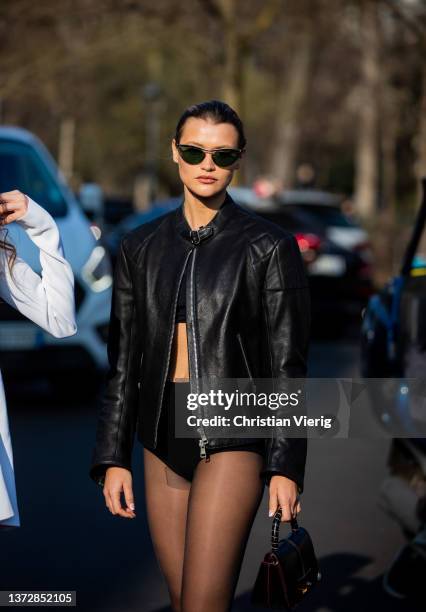 Chloe Lecareux seen wearing black jacket, sheer tights, cropped top, mini shorts, brown bag outside Tod's fashion show during the Milan Fashion Week...