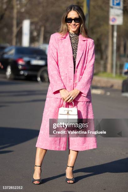 Tiany Kiriloff poses ahead of the Tod's fashion show wearing a pink suit during the Milan Fashion Week Fall/Winter 2022/2023 on February 25, 2022 in...