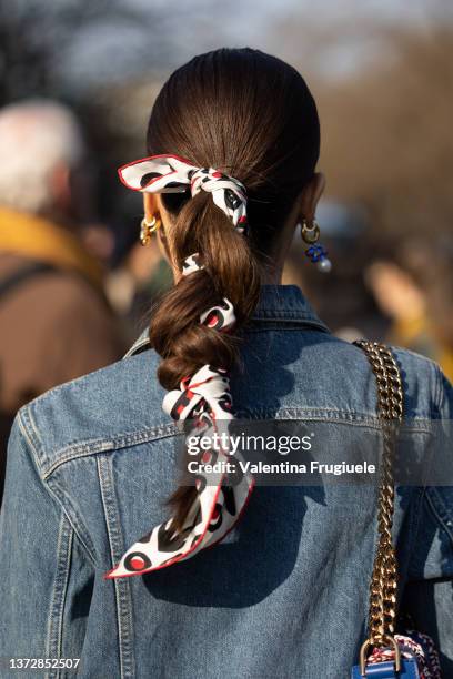 Guest poses ahead of the Tod's fashion show wearing a bandana braid during the Milan Fashion Week Fall/Winter 2022/2023 on February 25, 2022 in...