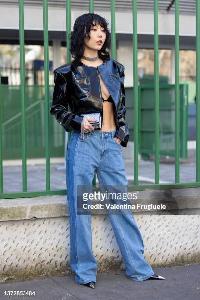 Guest poses ahead of the Missoni fashion show wearing a bra, vinyl jacket and chocker during the Milan Fashion Week Fall/Winter 2022/2023 on February...