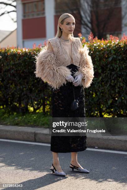 Leonie Hanne is seen ahead of the Gucci fashion show wearing a feather sleeves blouse during the Milan Fashion Week Fall/Winter 2022/2023 on February...