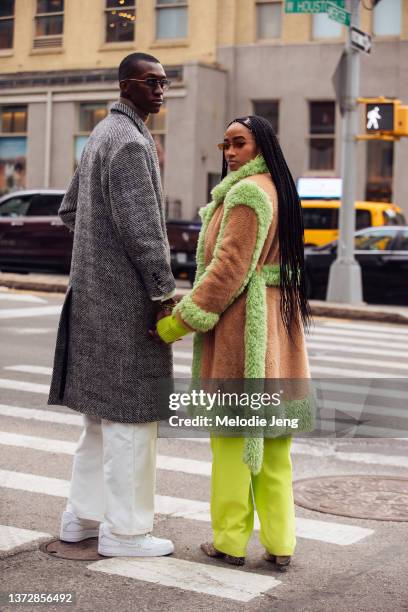 Couple Alioune Badara Fall and Candace Marie Stewart hold hands and look over their shoulder at the Collina Strada presentation/screening at Angelika...