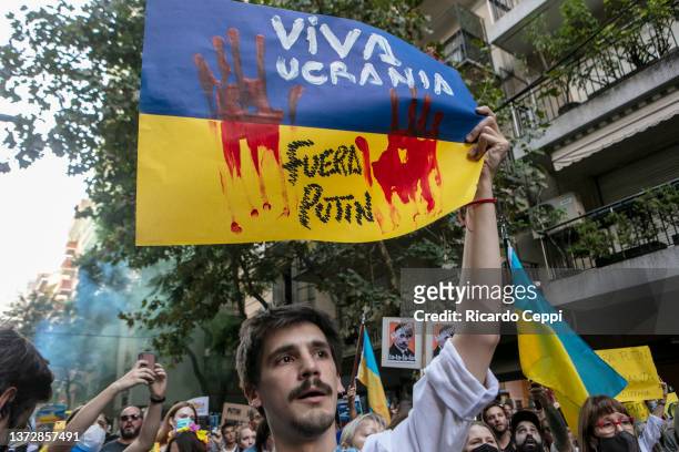 Person holds tu support Ukraine during a protest against the war in front of the Russian Embassy in Buenos Aires on February 25 in Buenos Aires,...