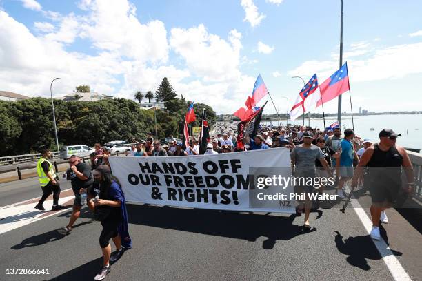 Anti-Covid vaccine mandate protesters march over the Auckland Harbour Bridge on February 26, 2022 in Auckland, New Zealand. The Freedom and Rights...