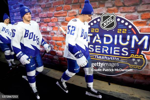 Mikhail Sergachev, Taylor Raddysh and Cal Foote of the Tampa Bay Lightning make their way to the ice surface for the Tampa Bay Lightning team photo...