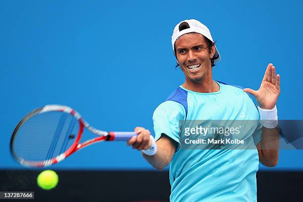 Juan Ignacio Chela of Argentina plays a forehand in his second round match against Pablo Andujar of Spain during day four of the 2012 Australian Open...