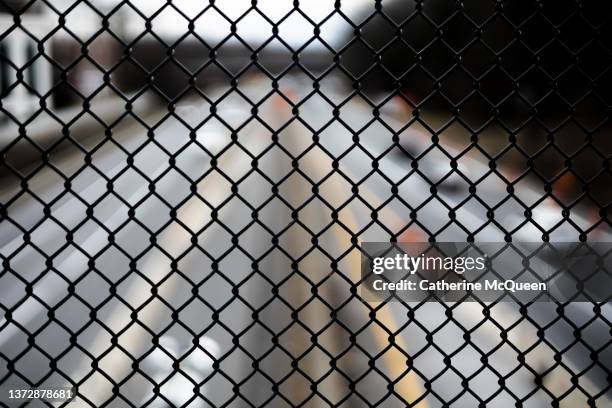 overhead view from bridge lined with wire fencing of highway with light traffic in both directions - chain fence stock-fotos und bilder