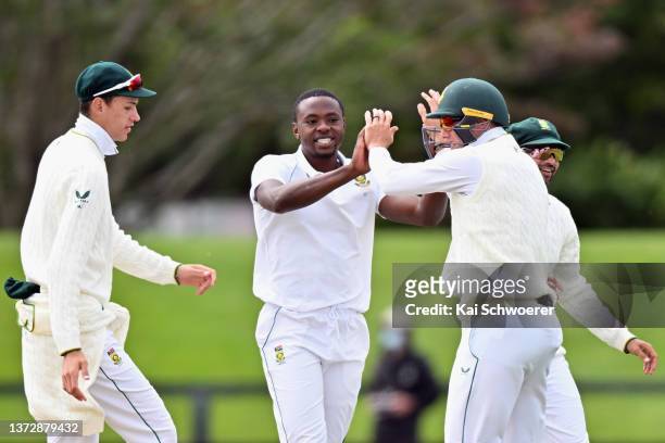 Kagiso Rabada of South Africa is congratulated by team mates after dismissing Tom Latham of New Zealand during day two of the Second Test Match in...