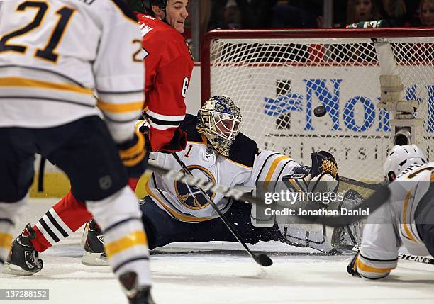 Andrew Shaw of the Chicago Blackhawks slips the puck past Jhonas Enroth of the Buffalo Sabres for a goal at the United Center on January 18, 2012 in...