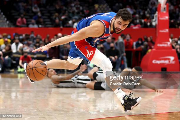 Deni Avdija of the Washington Wizards reaches for the ball during overtime against the San Antonio Spurs at Capital One Arena on February 25, 2022 in...