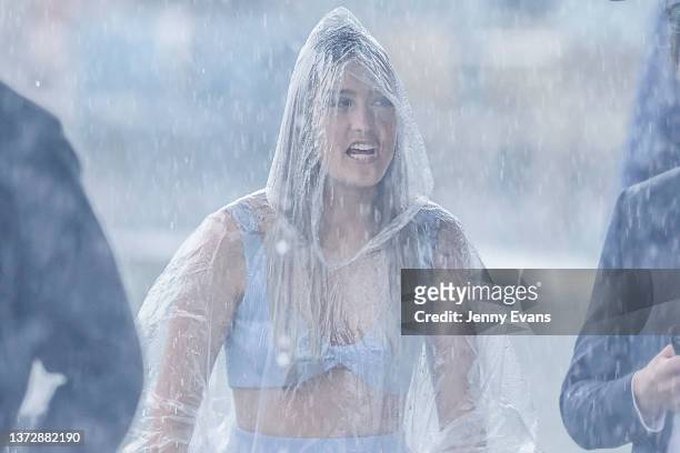 Woman is seen in seen in the rain during Sydney Racing at Royal Randwick Racecourse on February 26, 2022 in Sydney, Australia.